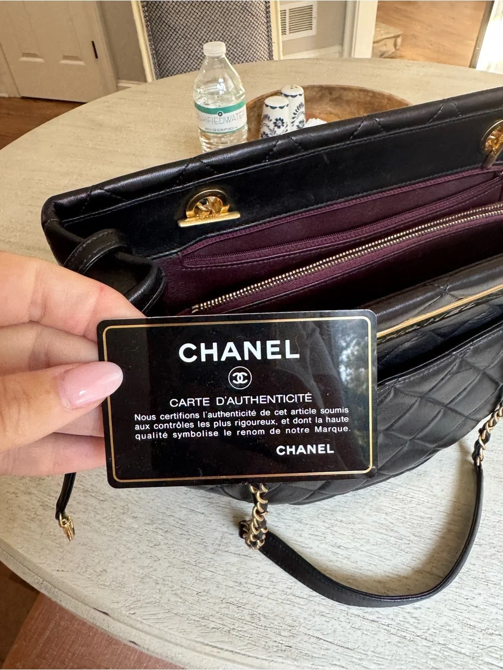 CHANEL Black Quilted Leather Shoulder Bag with Gold-Tone Plate and CC Charm